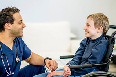 Provider talking to a child in a wheelchair