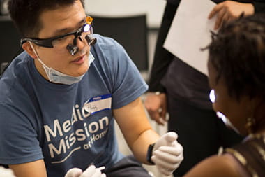 Medical mission volunteer assisting a patient