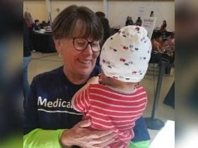 Volunteer holding child