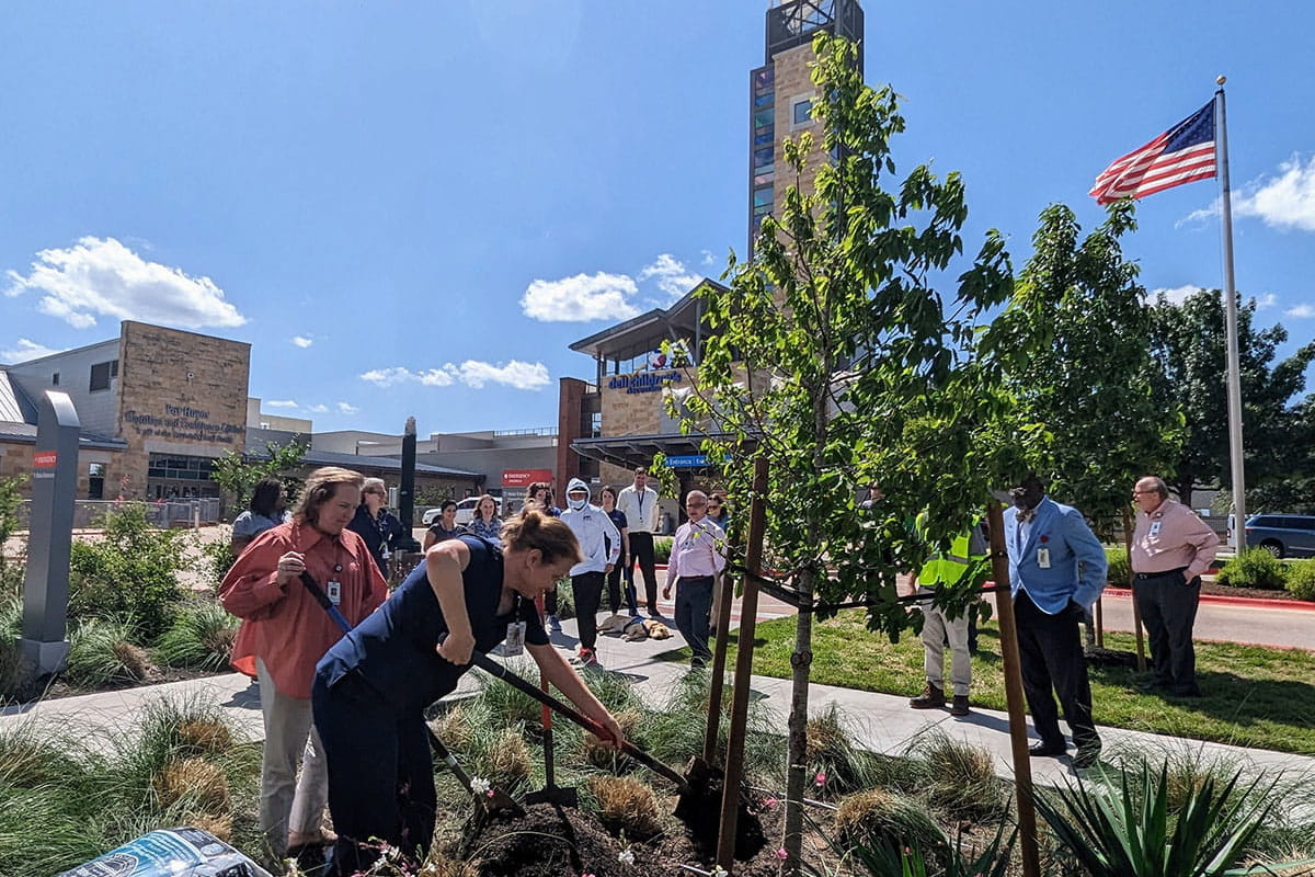 Associates with Dell Children’s Medical Center in Austin, Texas, plant a tree in honor of Earth Day 2023.