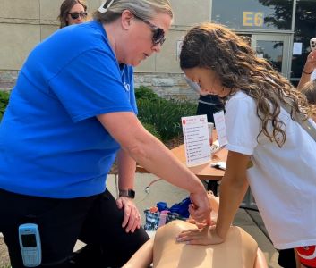 girl learning CPR.