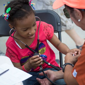 Young girl listening with a stethoscope