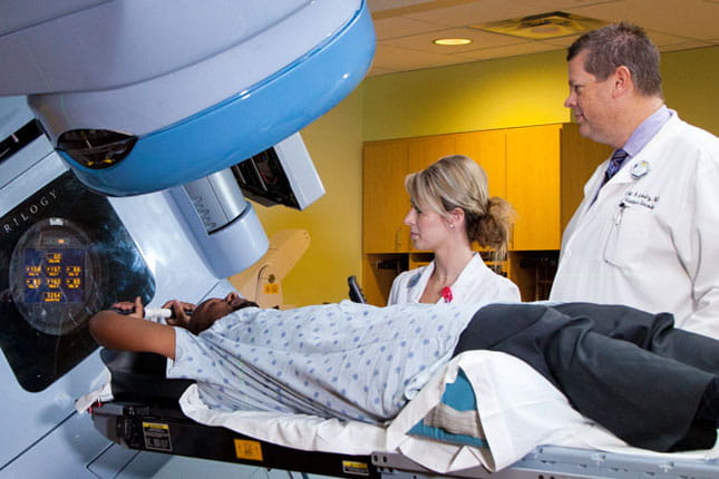 Doctors with patient in an imaging machine