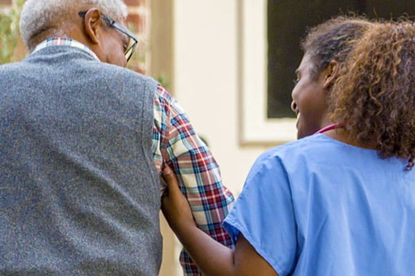 Caregiver walking with patient