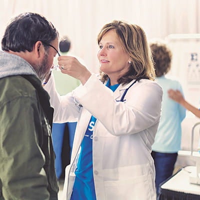 Doctor assisting patient with glasses