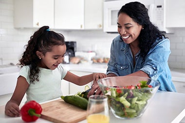 Mother and daughter preparing food